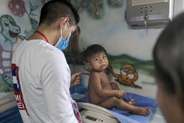 Between conflict and water, the hospital ship of the Pacific Region of Colombia - A small sick child receives medical attention from one of the doctors from the humanitarian...