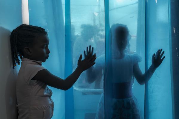 Between conflict and water, the hospital ship of the Pacific Region of Colombia - Two little girls play at the entrance door to the San Raffaele Hospital Ship, while they wait to...