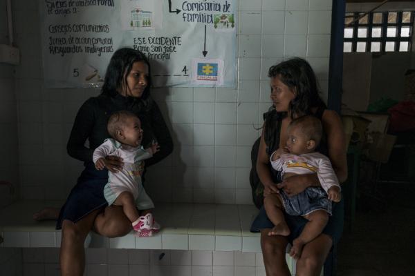 Between conflict and water, the hospital ship of the Pacific Region of Colombia - Two indigenous women from the Cauca region of Colombia wait with their small children to receive...