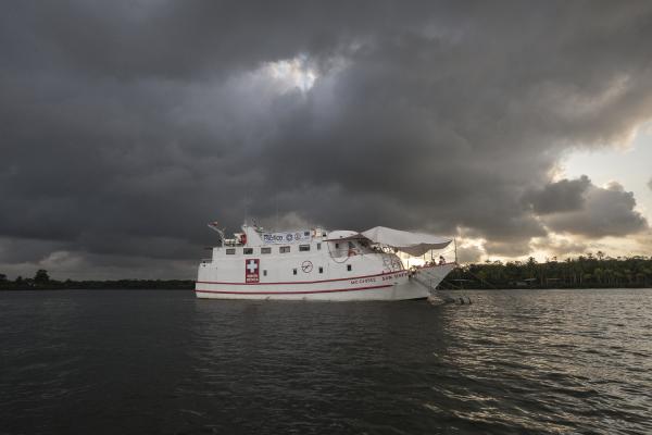 Between conflict and water, the hospital ship of the Pacific Region of Colombia - Sunset view of the San Rafaelle Hospital Ship that is anchored on the current of the Saija River...