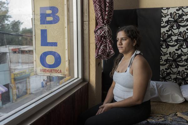 The tortuous journey, the migration through America - Janeika looks through the window of a hotel in the town of Huehuetoca, thinking about how her...