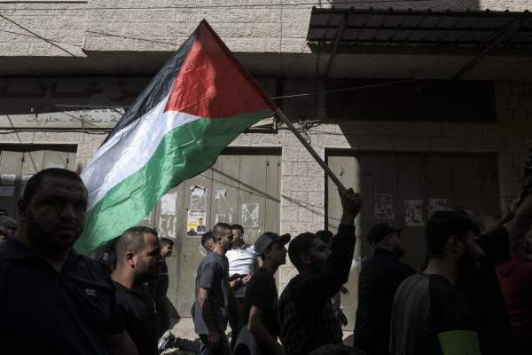 Funeral in West Bank - Men carry the Palestinian flag during the funeral of Ibahim Zayad who was shot dead by the...