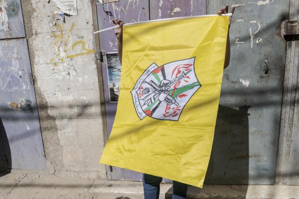 Funeral in West Bank - A yellow Fatah flag is displayed during the funeral of Ibrahim Fayad in the West Bank. Qualandya...