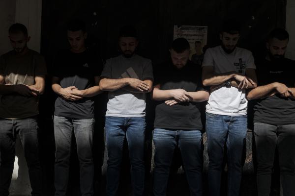 Funeral in West Bank - A group of men pray during the funeral of Ibrahim Zayad who died from gunfire by the Israeli...