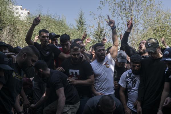 Funeral in West Bank - A group of men shout during the burial of Ibrahim Zayed, a 29-year-old man who was shot dead by...