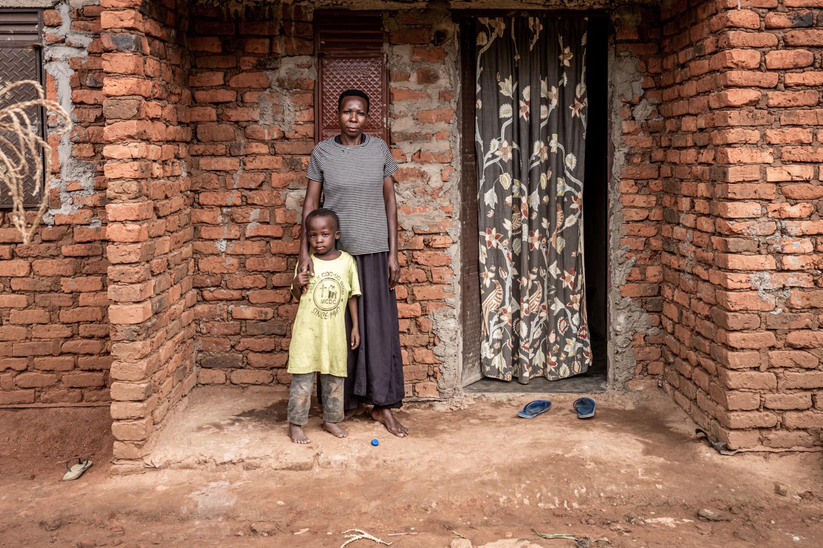 Efua and her daughter outside their home.