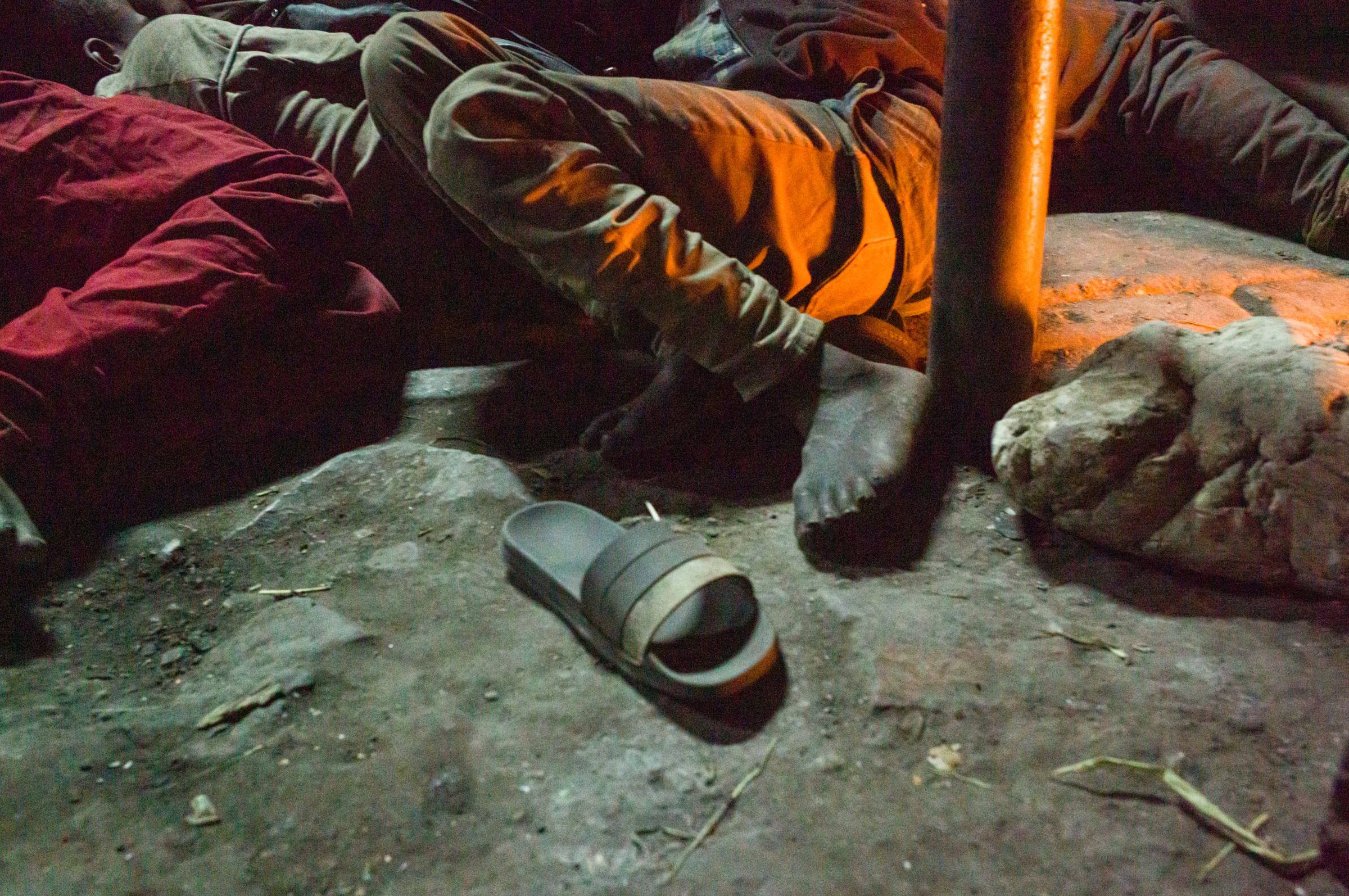 Life on the street in Lusaka - Sleeping on the streets - literally, on the hard pavement. The shoe is a reminder that the total...