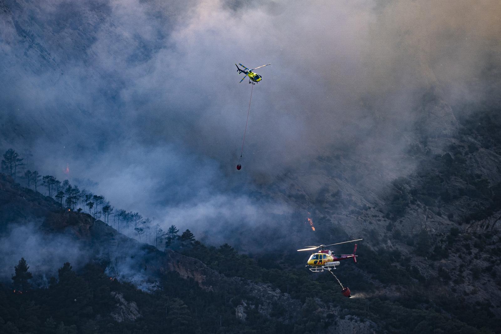 DAILY NEWS - Two firefighting helicopters of firefighters are working...