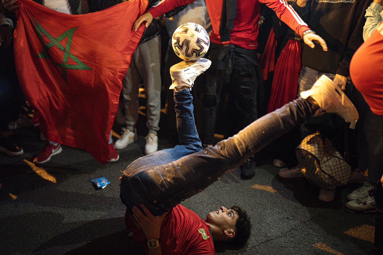 Image from DAILY NEWS - A Morocco fans juggles with a soccer ball during...