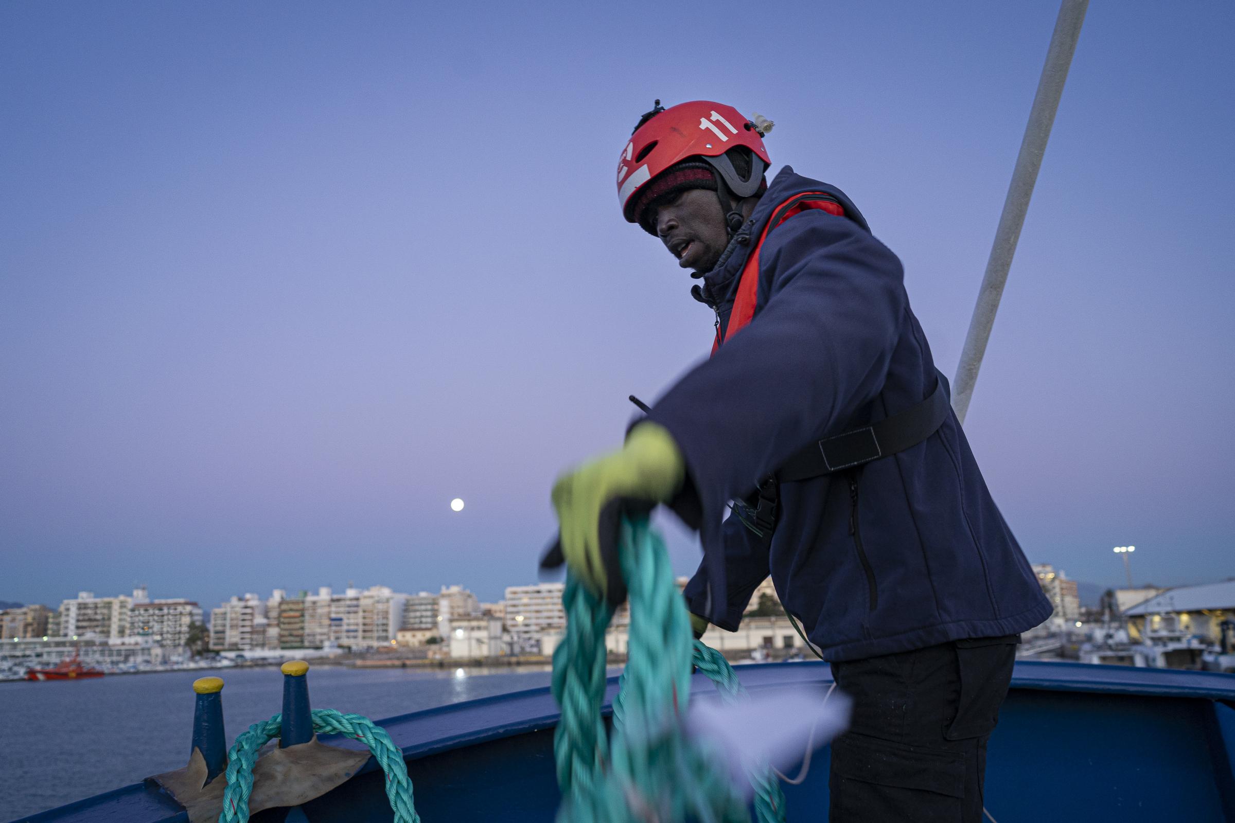  Edouard Thiam (37), picks up a line on the bow of the Aita Mari early in the morning during...