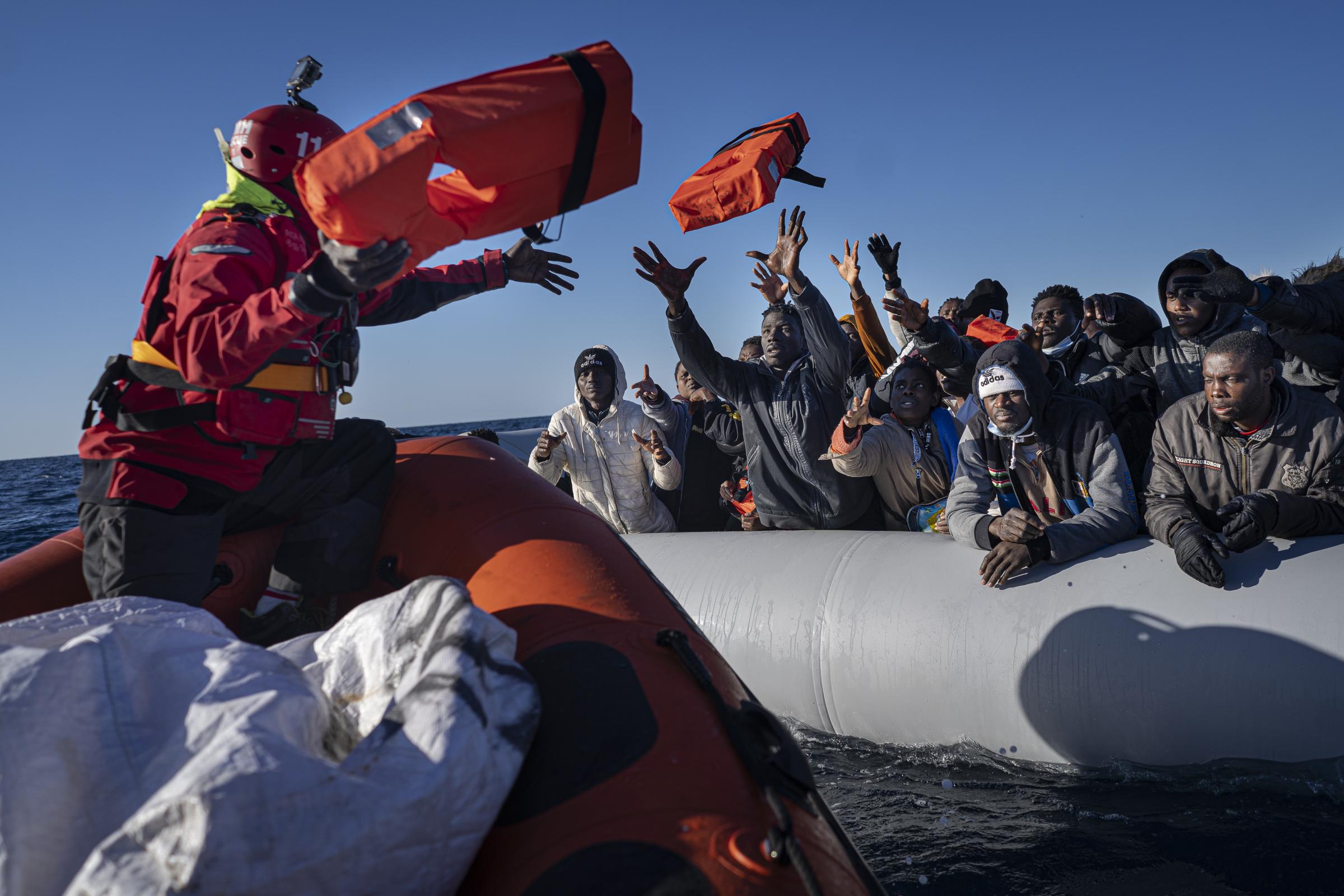 The 7th mission -  Edouard throws life jackets to refugees drifting in an...