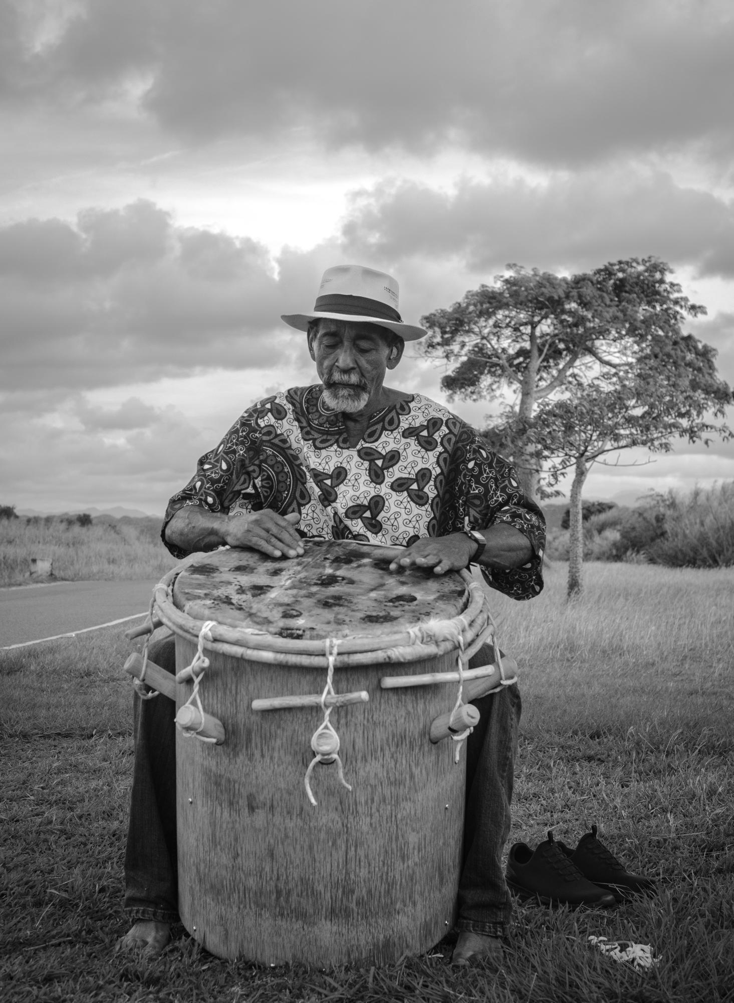 Survived by Few - Smithsonian Magazine Cover Story - Master artisan Rafael Trinidad plays a Bomba drum made out of Puerto Rican Royal Palm Tree and...