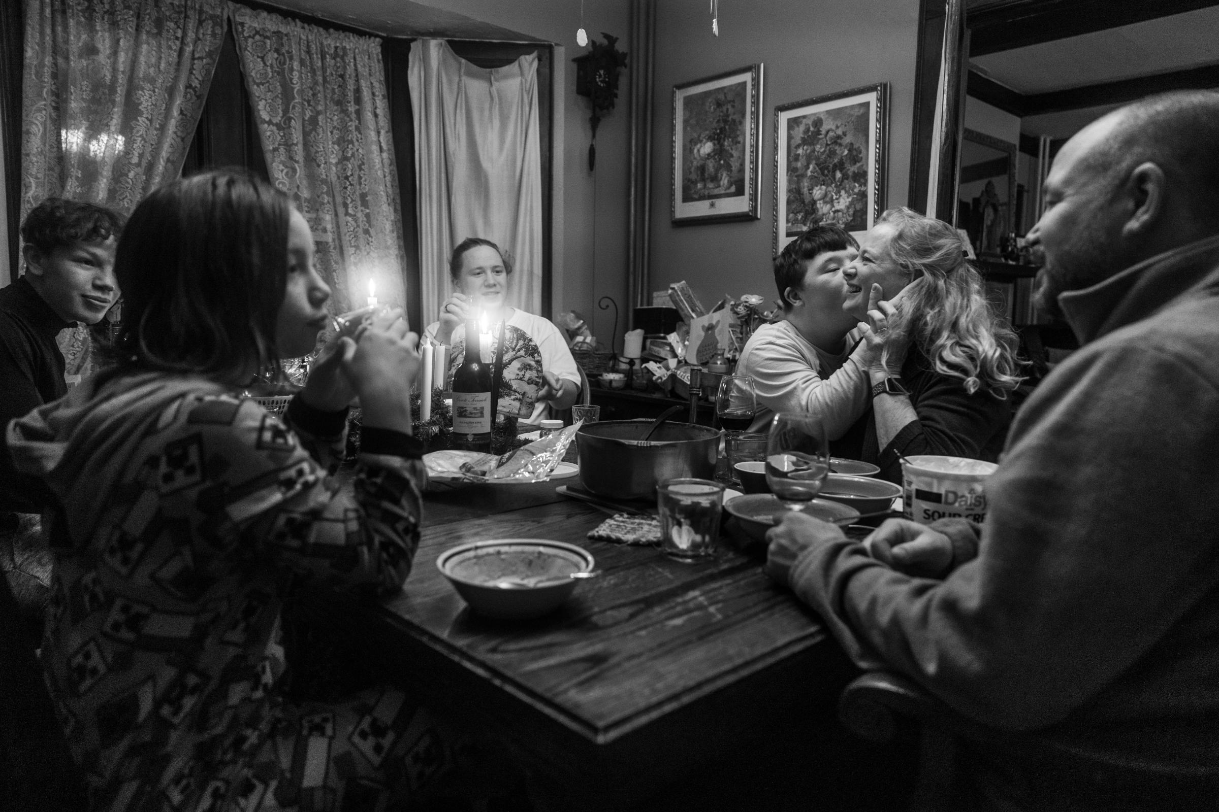 The Saufley family gathers for their daily dinner together around the table at their home in Syracuse, New York on November 30, 2021. The Saufley’s...