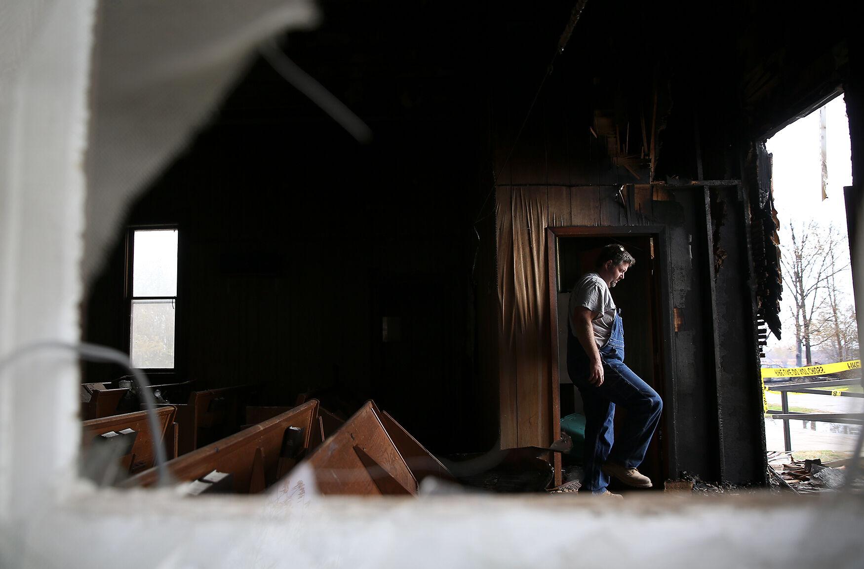 Wooldridge Fire - Tracy Friderich walks through the charred remnants of the...
