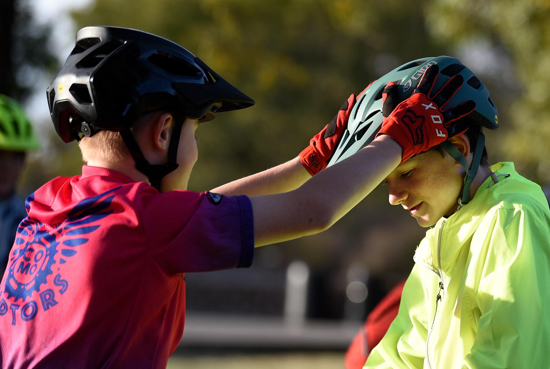 Mountain Biking - John Huffington adjusts Kaid Shaw’s helmet before...