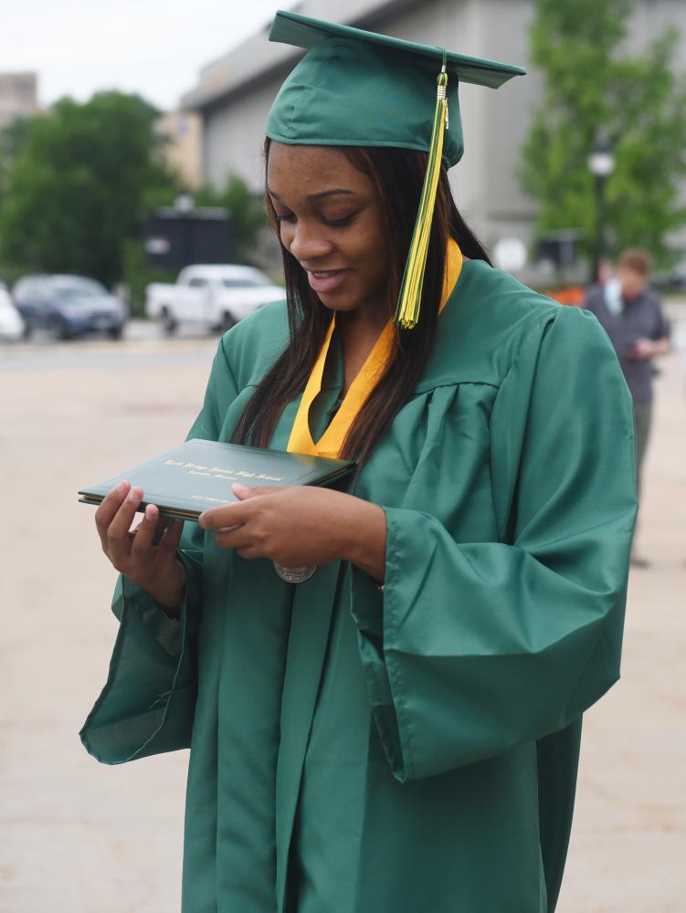 Rock Bridge graduate Aris Collier holds her diploma on Friday, May 21, 2021 at Mizzou Arena in Columbia. Megan Matty/Missourian