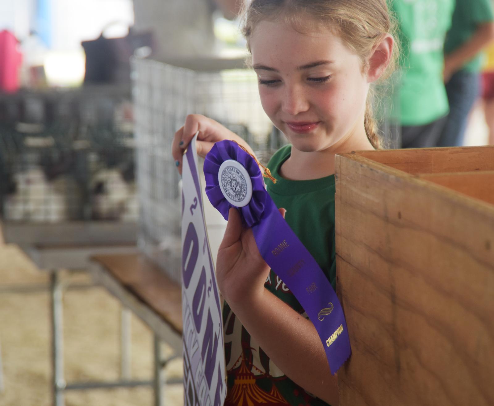 Johanna Roberts holds her ribbon Thursday, July 22, 2021 at the Boone County Fairground in Columbia. Roberts’ rabbit, Bucky, won best breeding rabbit. 
