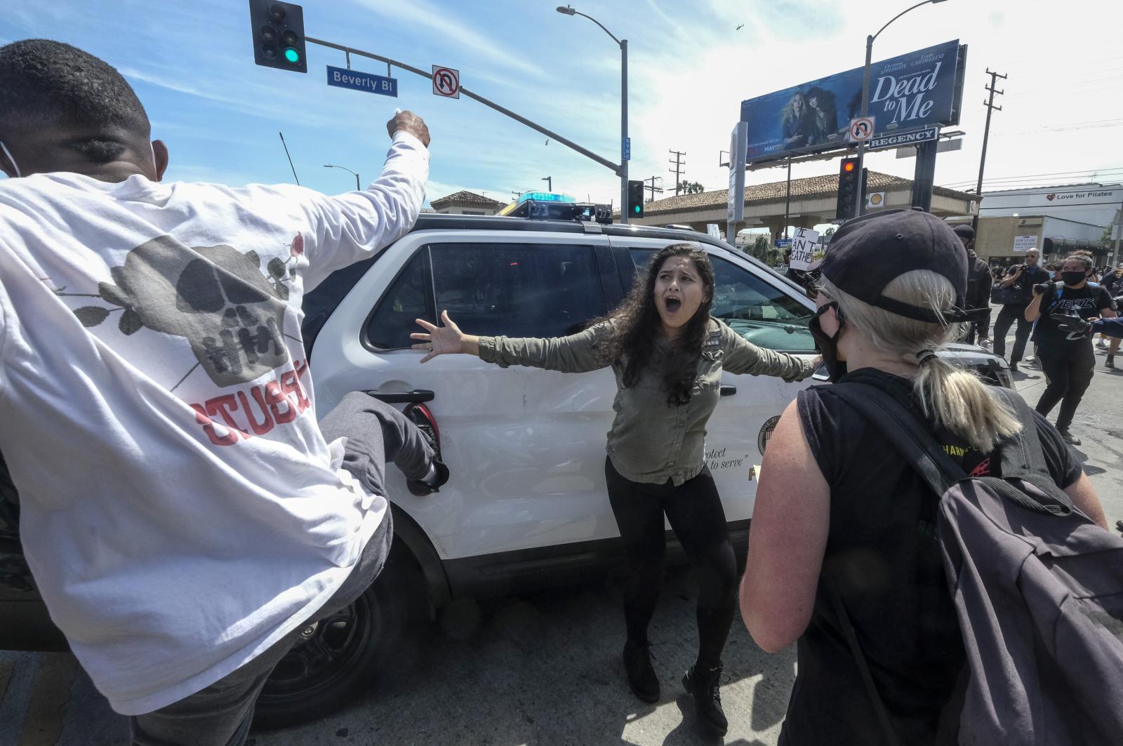 A protester, center, tries to s... in Los Angeles, May 30, 2020. 