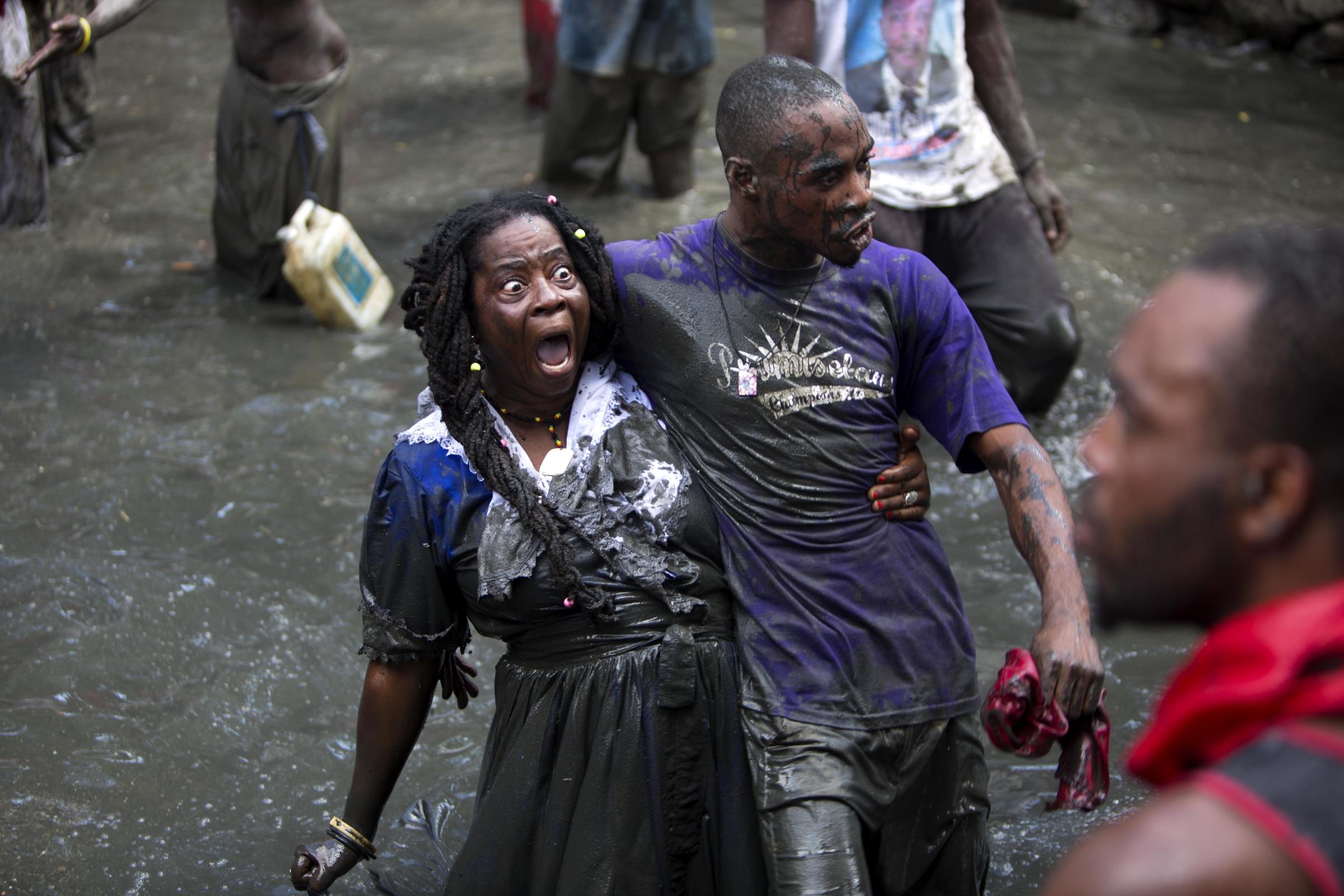 Vodou in Haiti - In this July 24, 2016 photo, pilgrims take a bath in a...