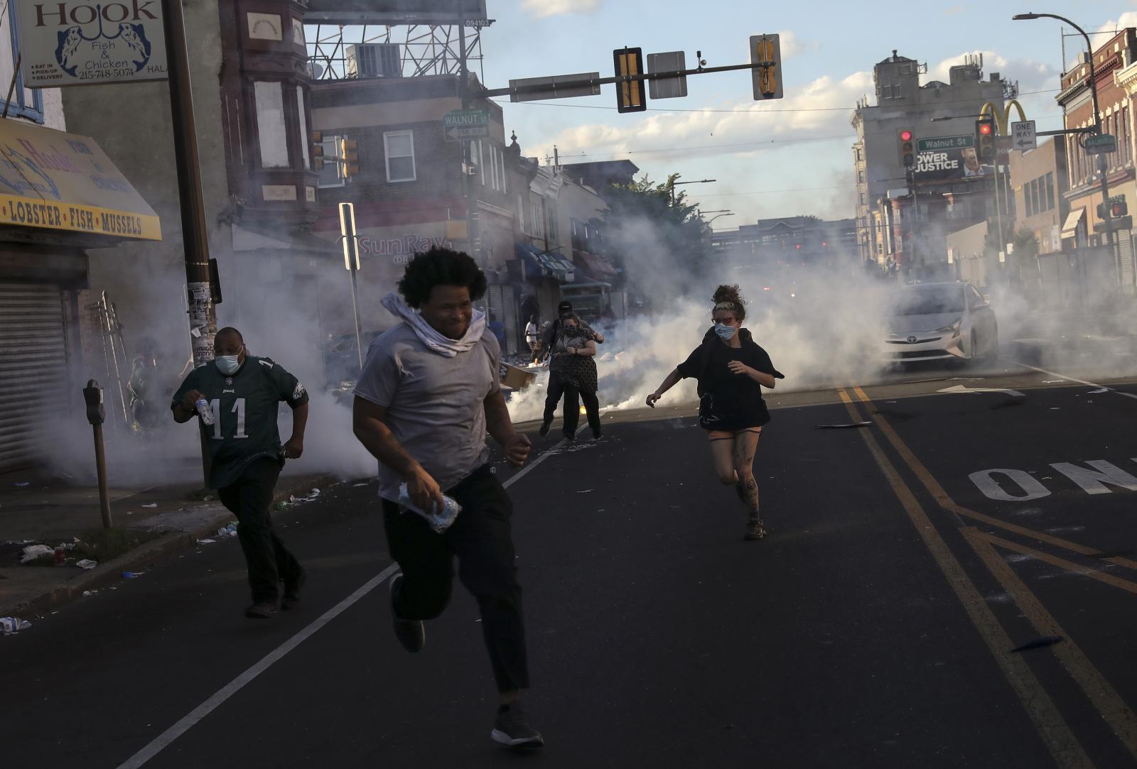 Protesters run as police fire t...rious sections of Philadelphia.