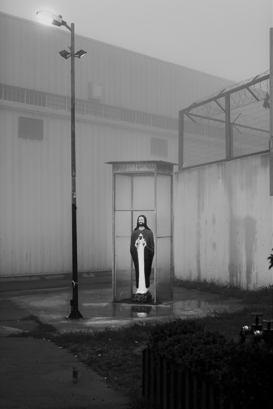 Grid Nº5/Reja Nº5 - A sculpture of Jesus made by inmates stands in a small clearing of light between the walls of the...