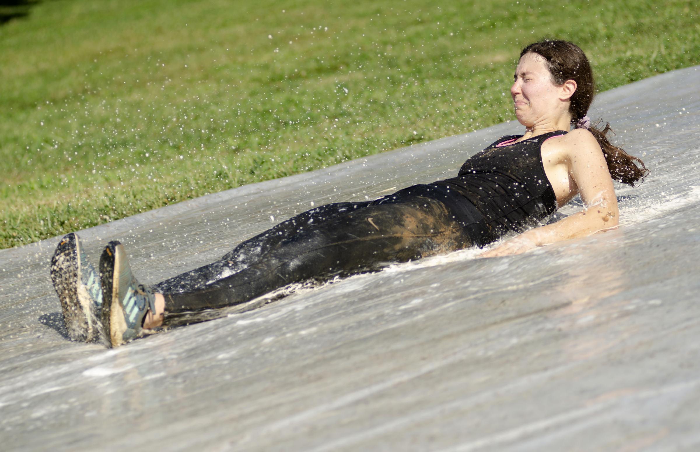 Community  - Paige Loyd slides down a makeshift water slide on...