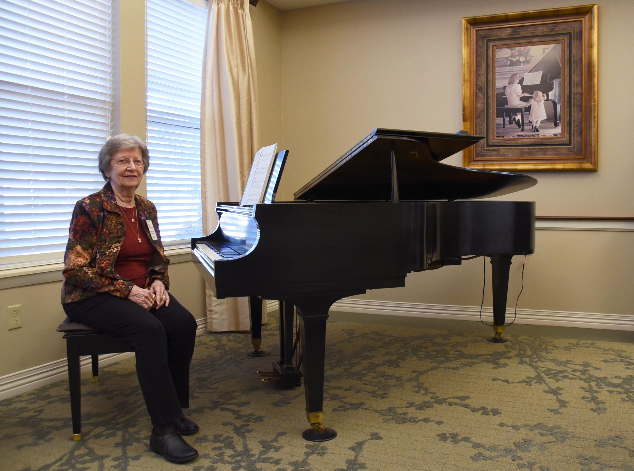 Photo essay: Home (ongoing) - Shirley Beckett poses for a photo with her piano on...