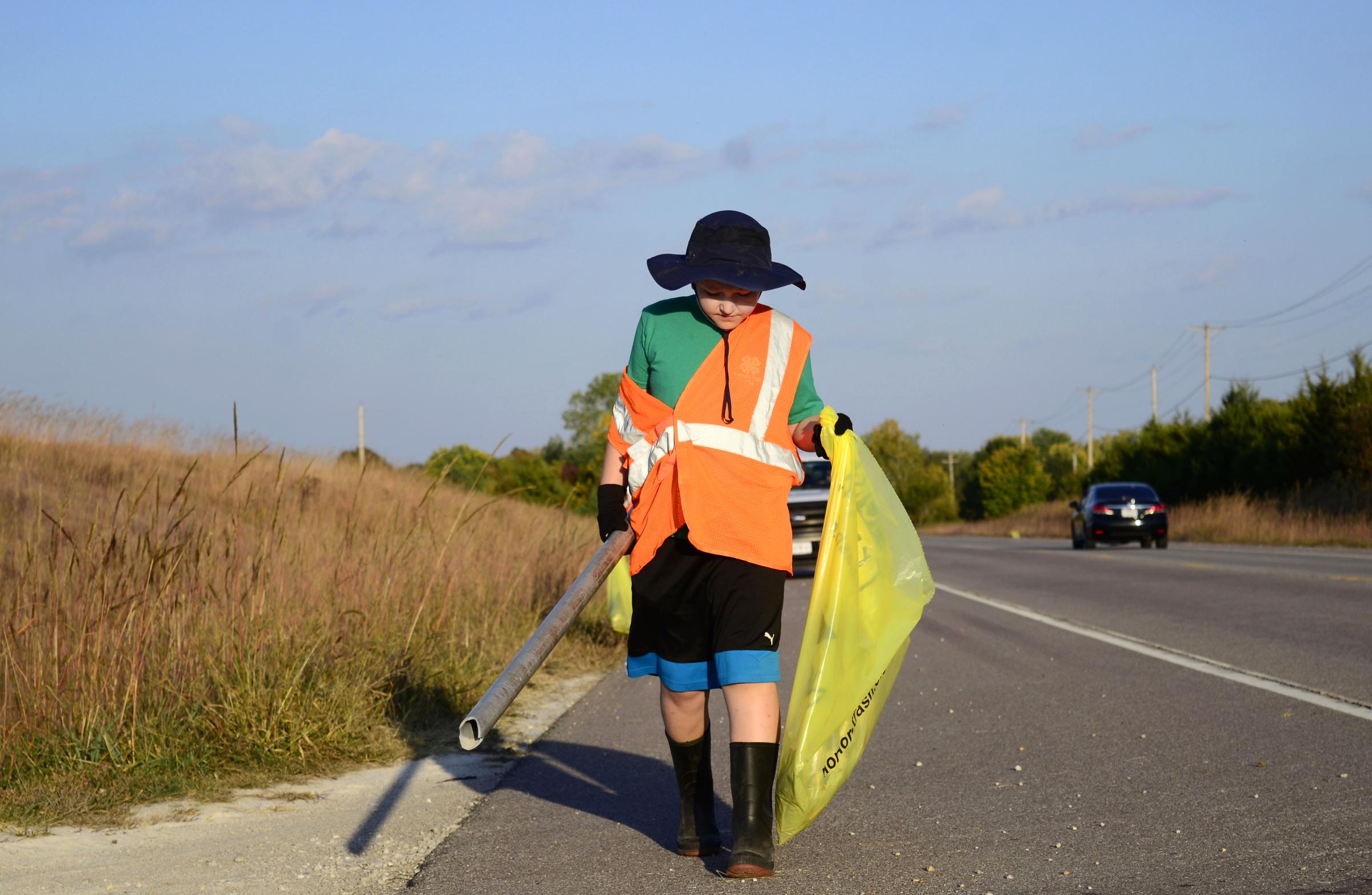 Community  - Liam Stapp, 9, walks with a discarded pole on Thursday,...