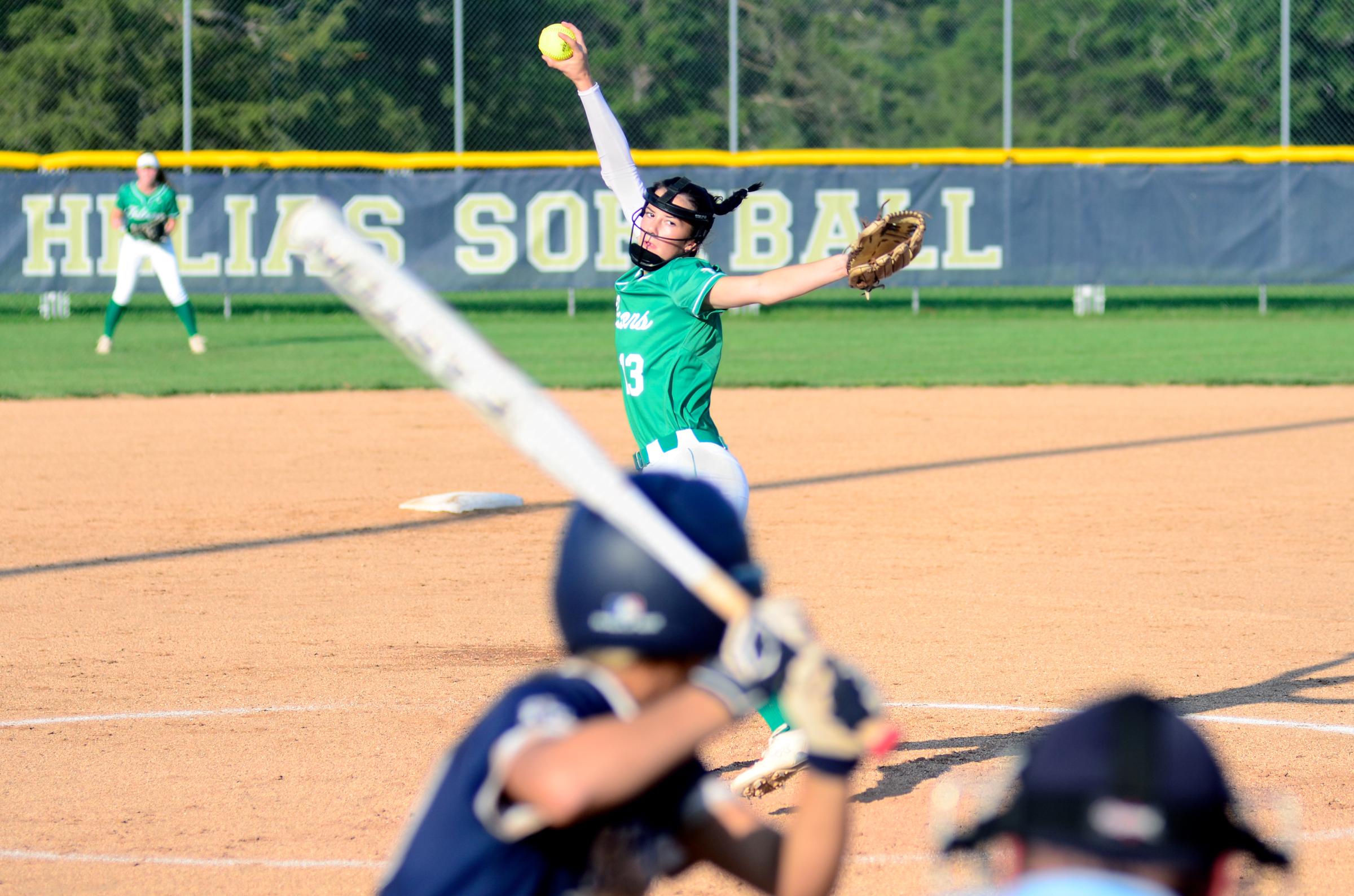 Blair Oaks pitcher Olivia Moyer throws the ball to the plate against a Helias batter during Tuesday&#39;s game at the American Legion Post 5...