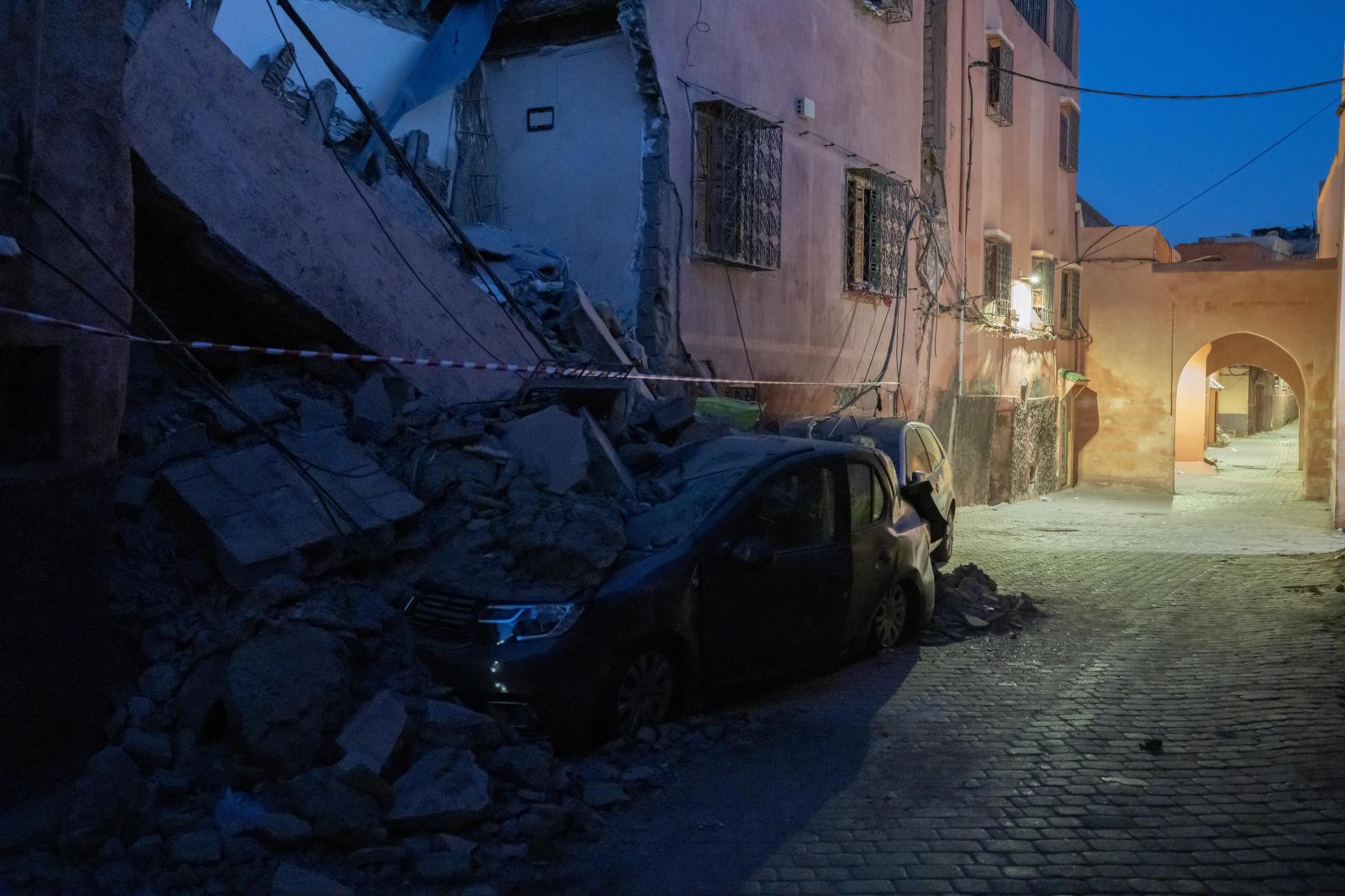 Rubble on vehicles damaged by a...Nariman El-Mofty) Marrakesh MAR