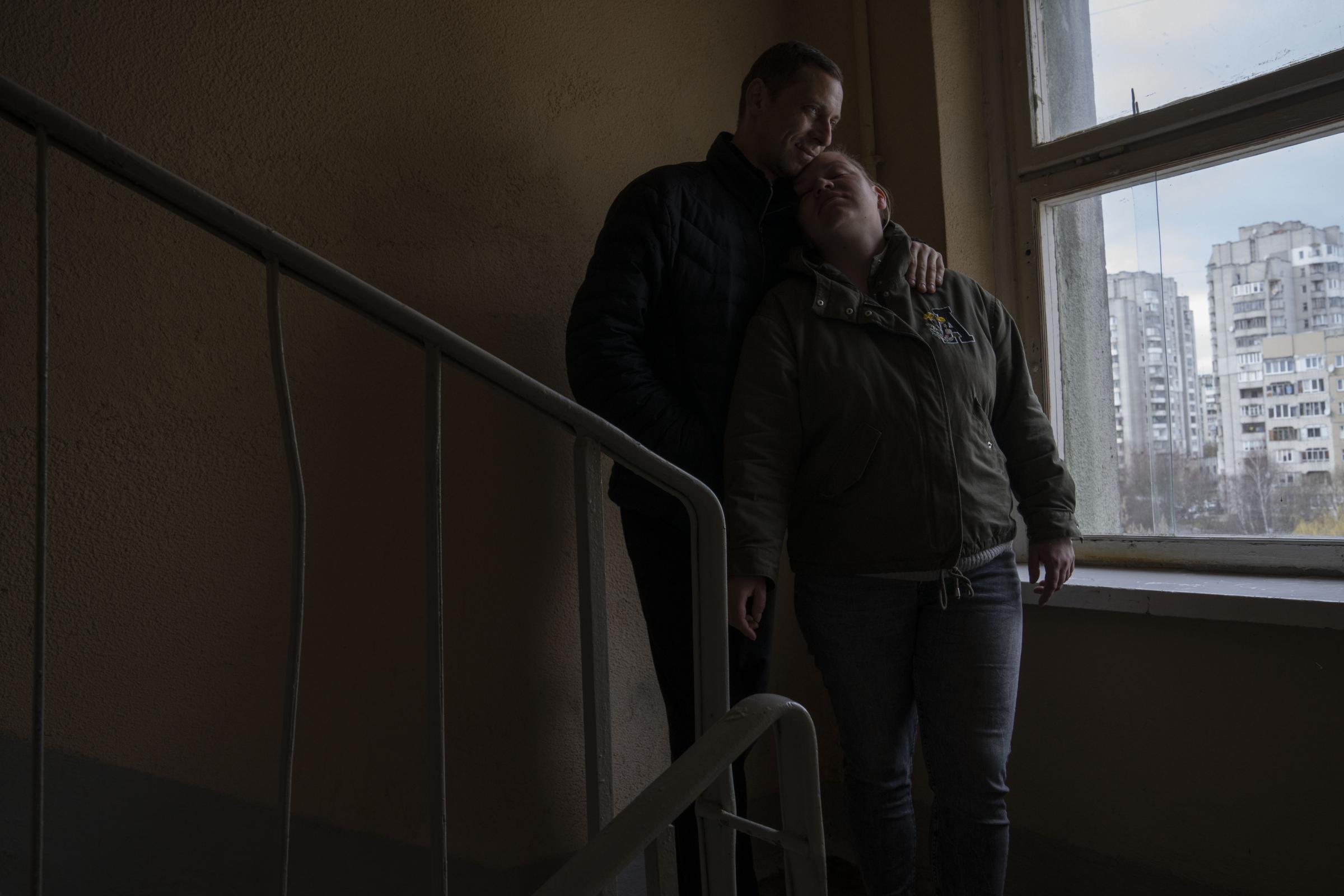 Iryna and Volodymyr, internally displaced from Irpin, lean on each other, on the stairwell near an apartment they took refuge in with four other adults from Irpin, in Lviv. Iryna and her husband Volodymyr were trapped for days between Ukrainian and Russian forces and quickly learned to distinguish between incoming and outgoing fire. They took shelter in a basement and whenever the shelling eased, they climbed out to shout to their neighbors to see if they were still alive.
