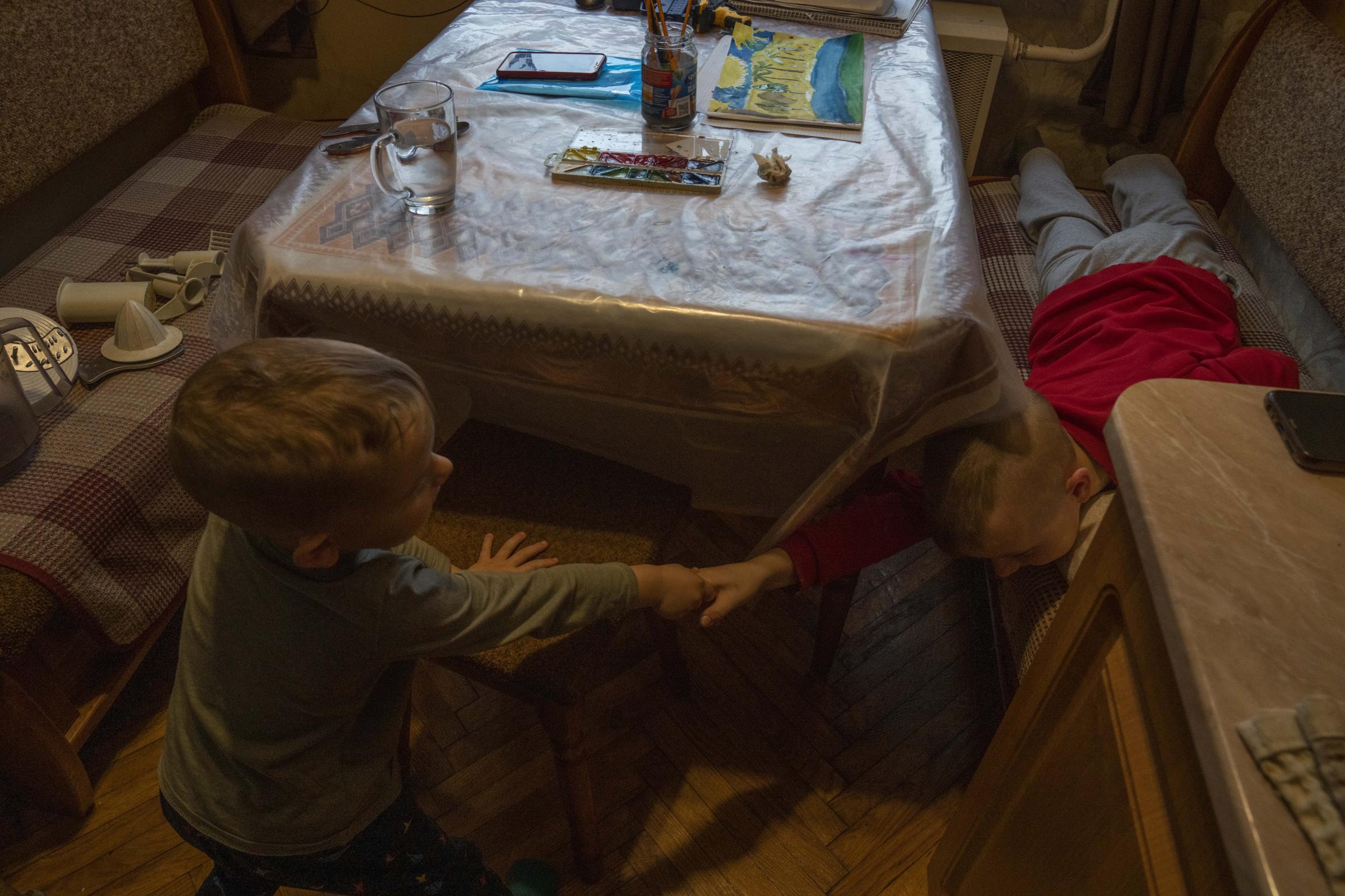 Makar, and his 6-year-old brother Nazar, play at an apartment where they took refuge after fleeing their home in Kyiv.