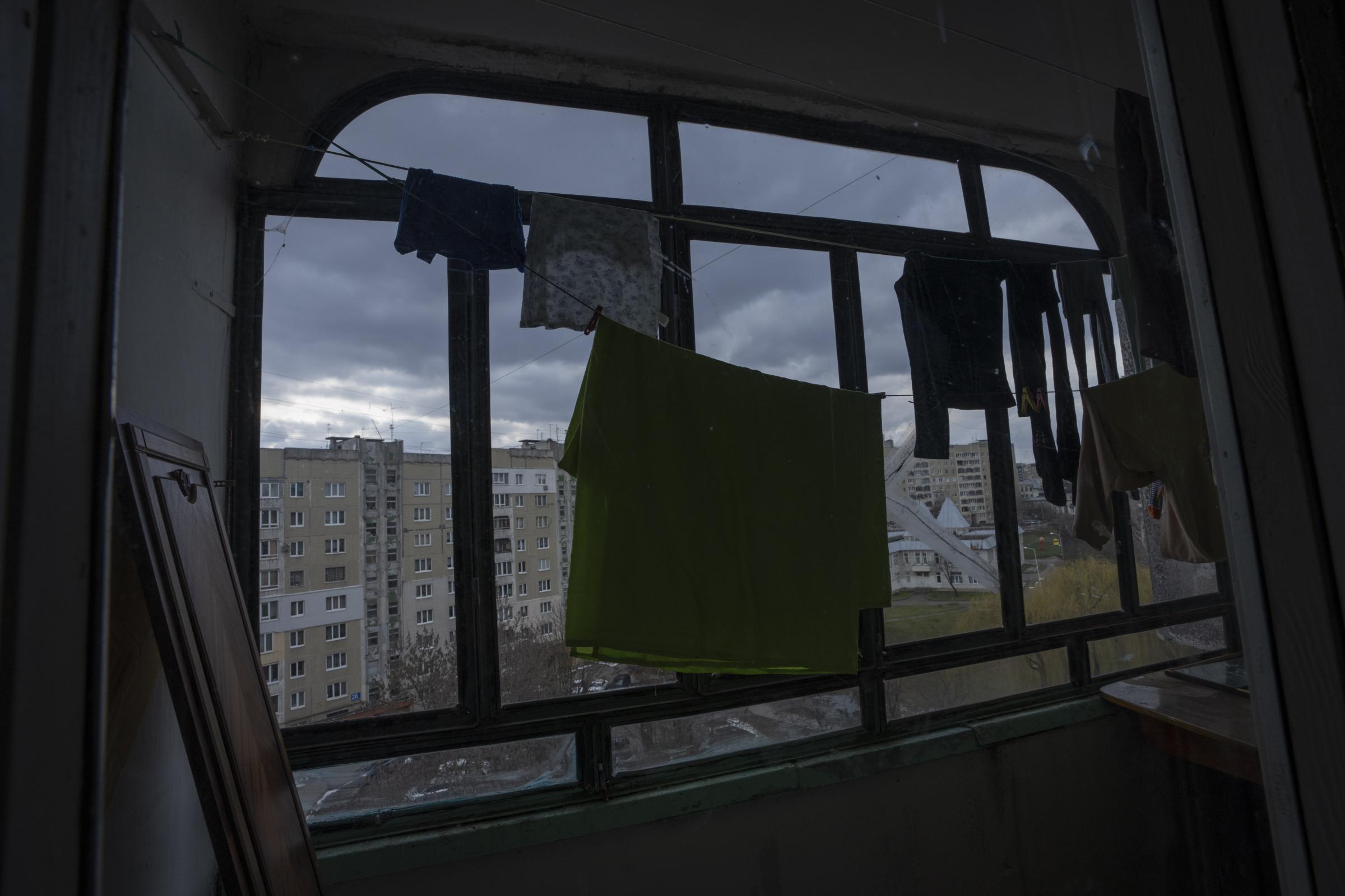 Clothes hang to dry in the apartment where the Shlapak family, who are internally displaced from Kharkiv, took refuge.