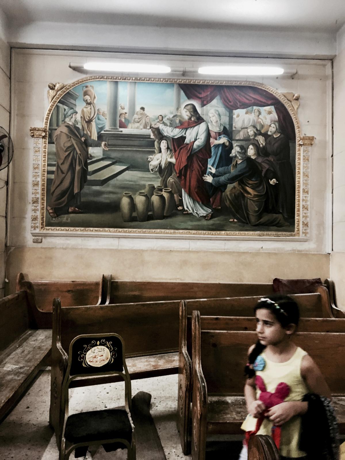  A girl looks at damages inside the St. George Church after a suicide bombing. (iPhone Photo - security refused access) 