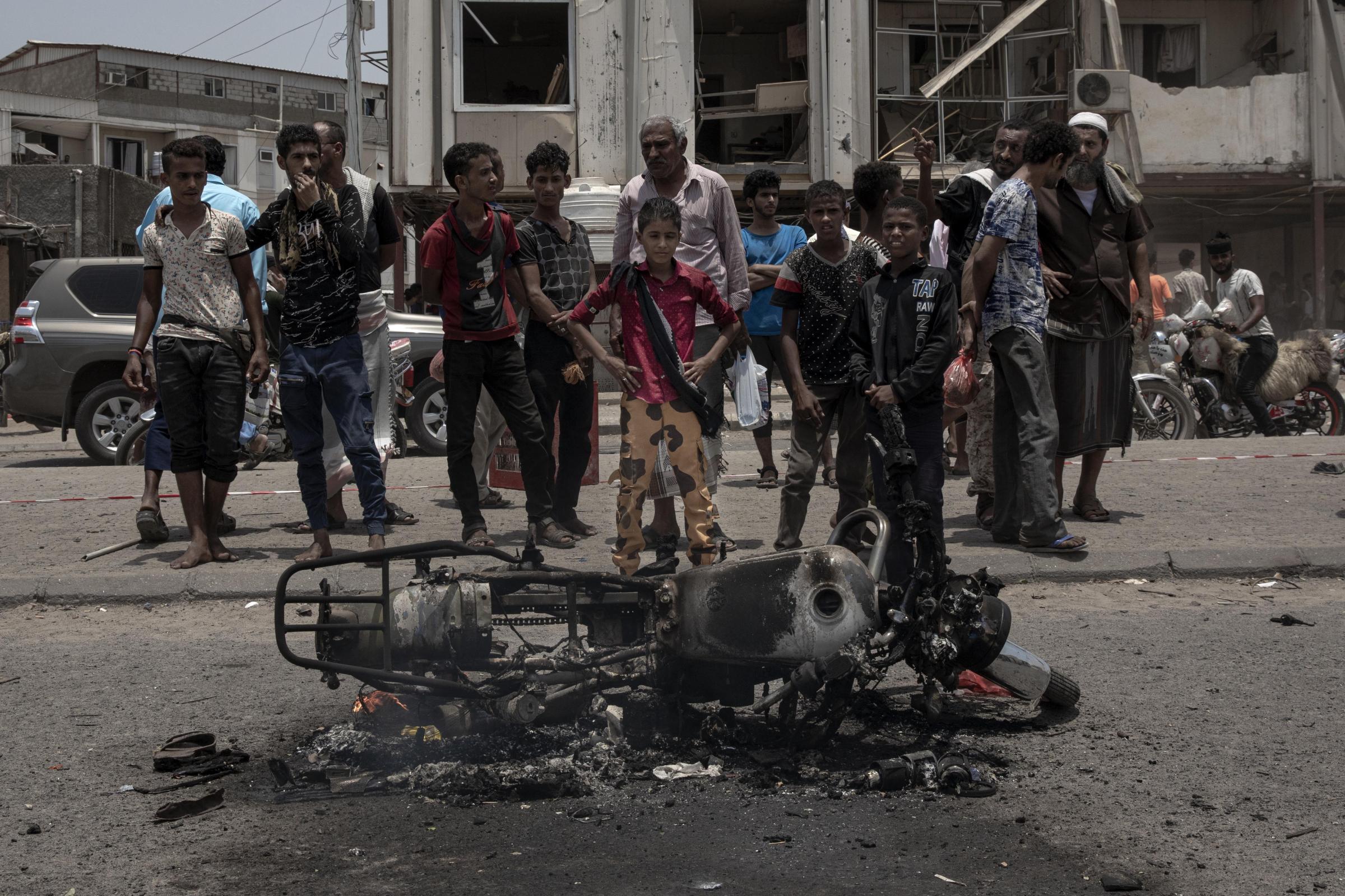  Civilians gather at the site of a deadly attack in Aden. 