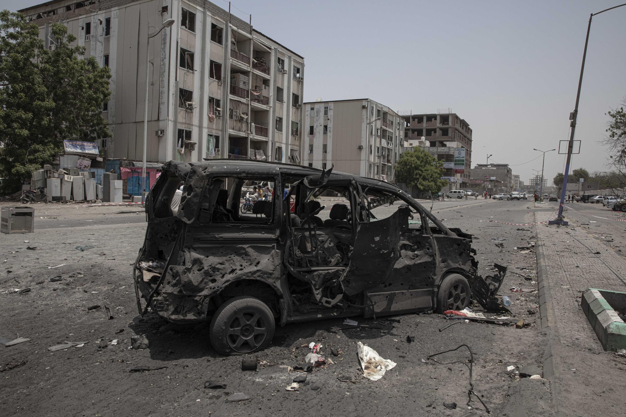  A destroyed vehicle remains at the site of a deadly attack on the Sheikh Othman police station in Aden. 