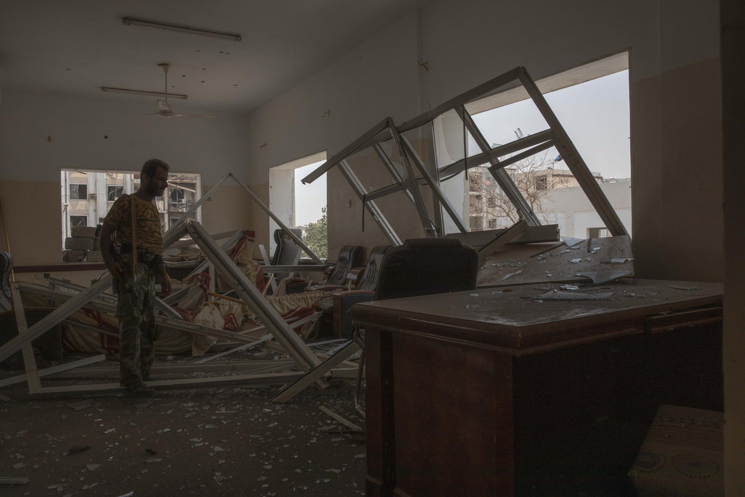 A solider looks at damage after a deadly attack on the Sheikh Othman police station. 
