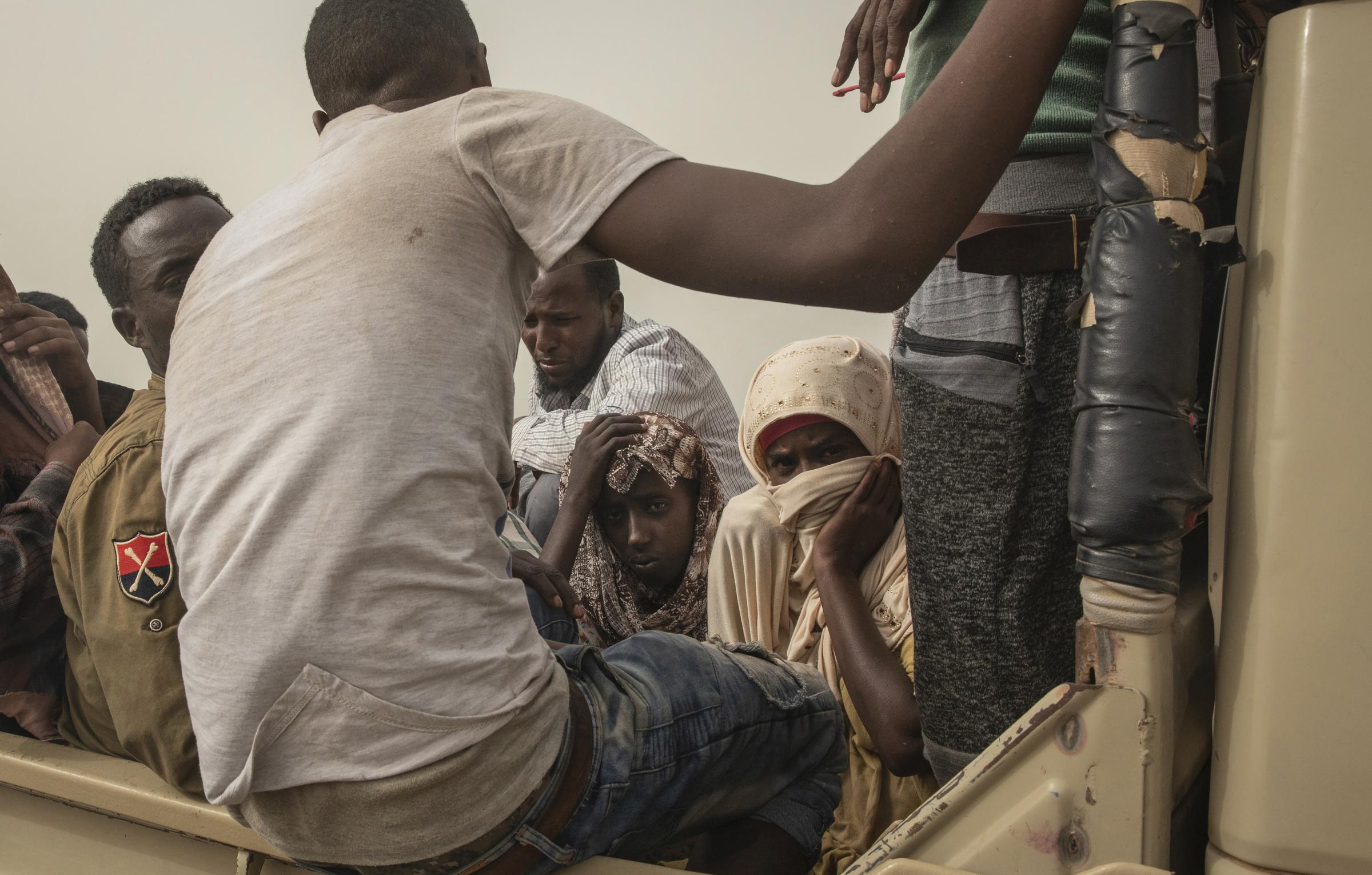 Migrants endure sea crossing to Yemen and disembark in hell -  Women being taken to "hosh," in Ras al-Ara. 