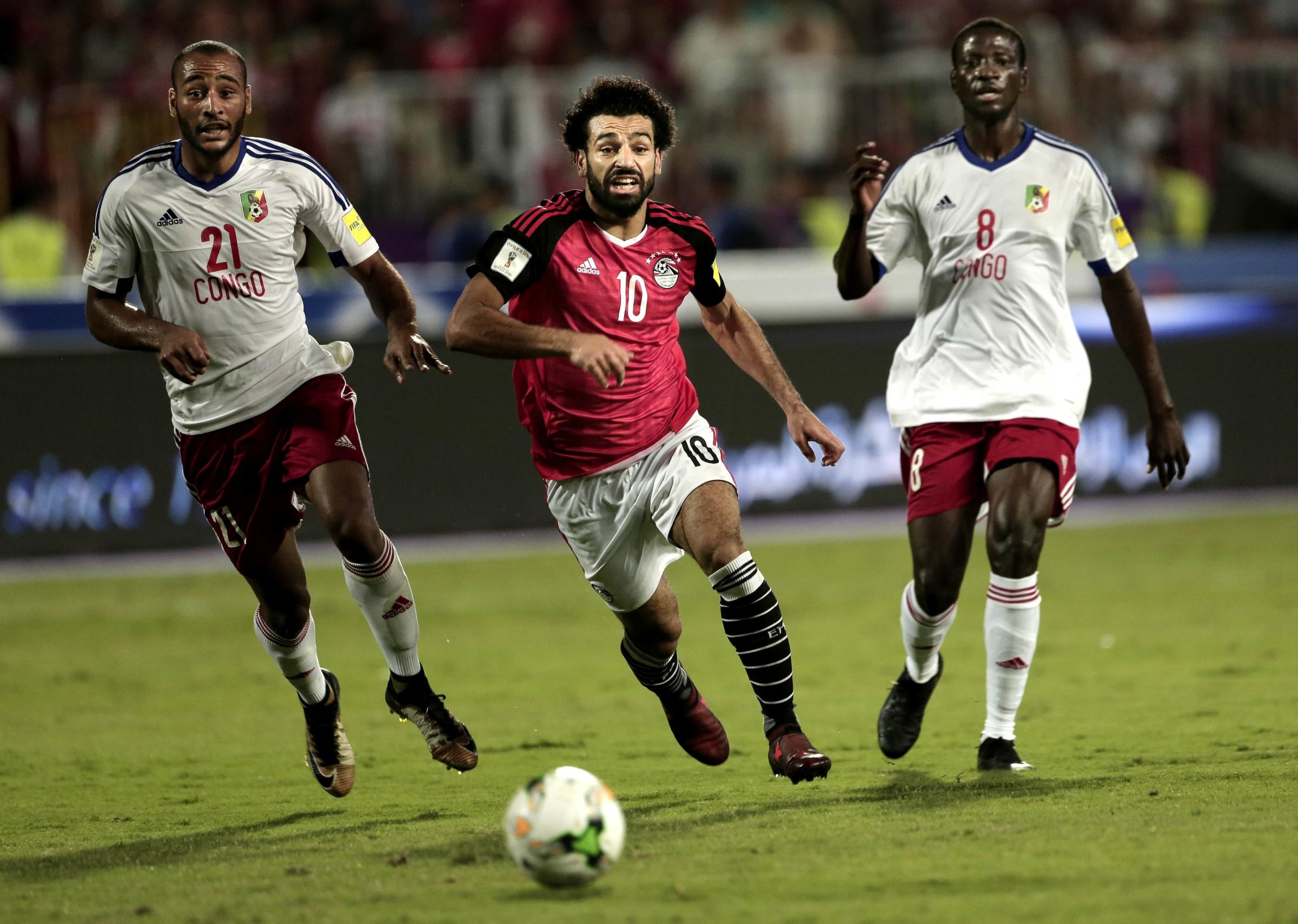  Salah battles for the ball with Congo&#39;s Delvin N&#39;Dinga, and Tobias Badila, at the Borg El Arab Stadium in Alexandria. 