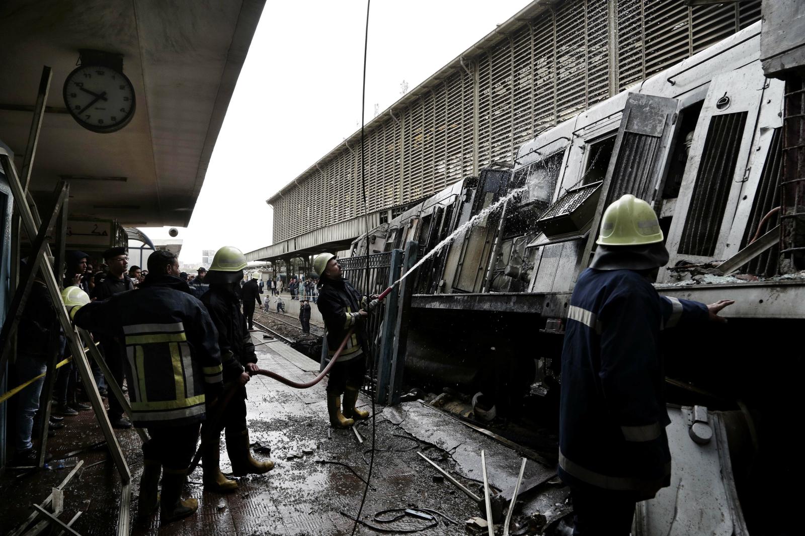  Firefighters hose down a train...Ramsis train station in Cairo. 