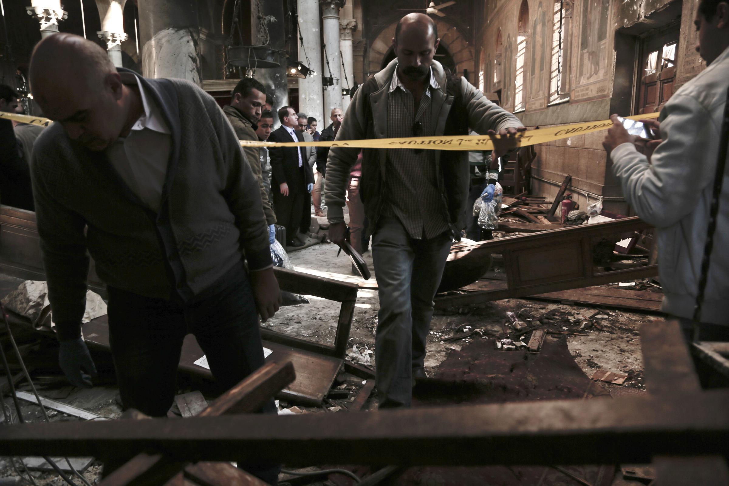 Egypt's main Coptic Christian cathedral attack -  Security forces investigate the scene inside St. Mark...