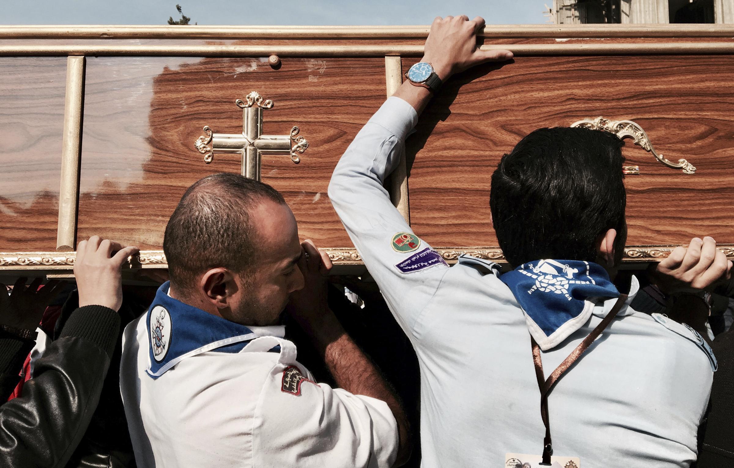 Egypt's main Coptic Christian cathedral attack -  Men carry a coffin of a victim of the Sunday cathedral...