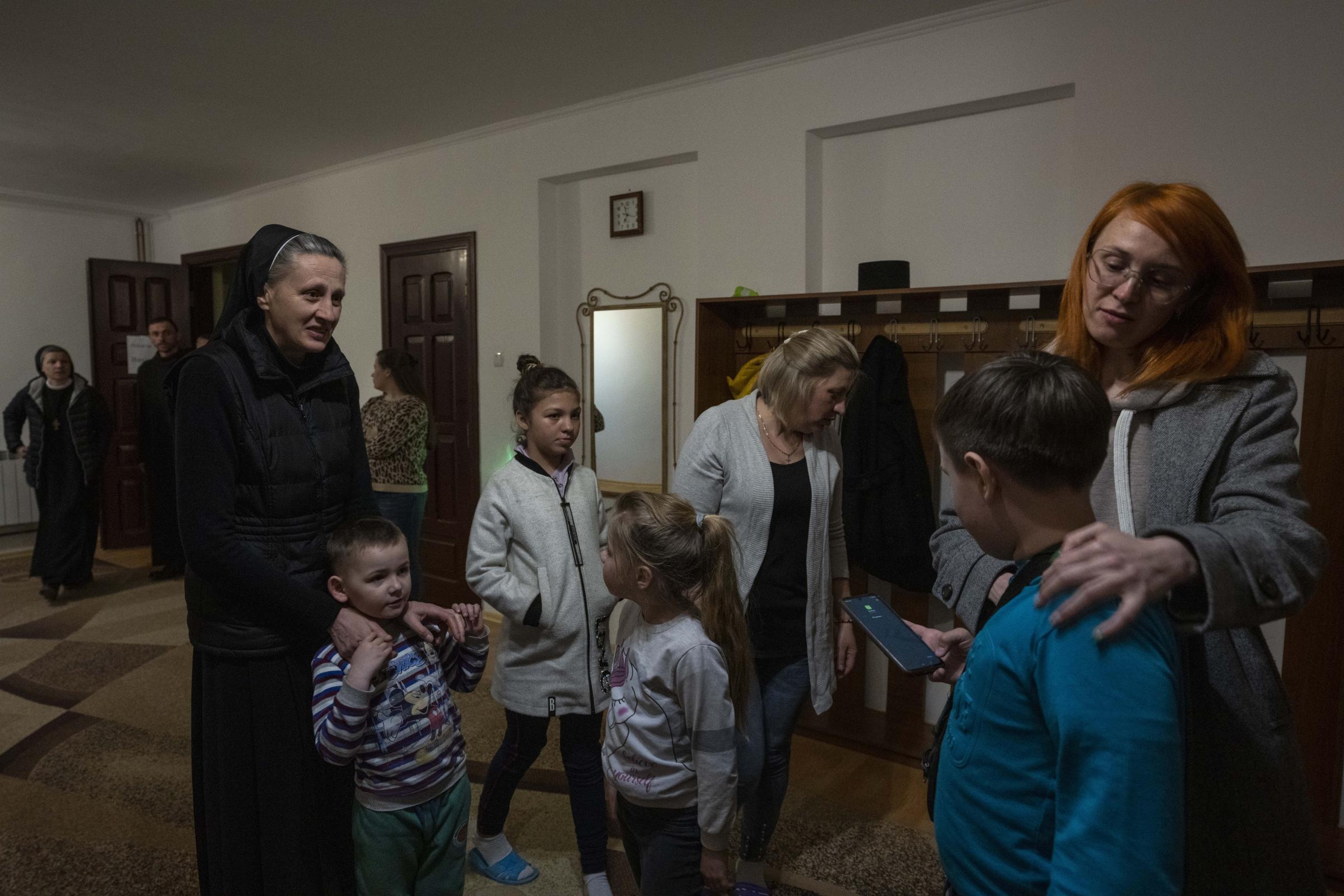 Ukraine's nuns open monastery doors to the displaced - Internally displaced families prepare to eat dinner.