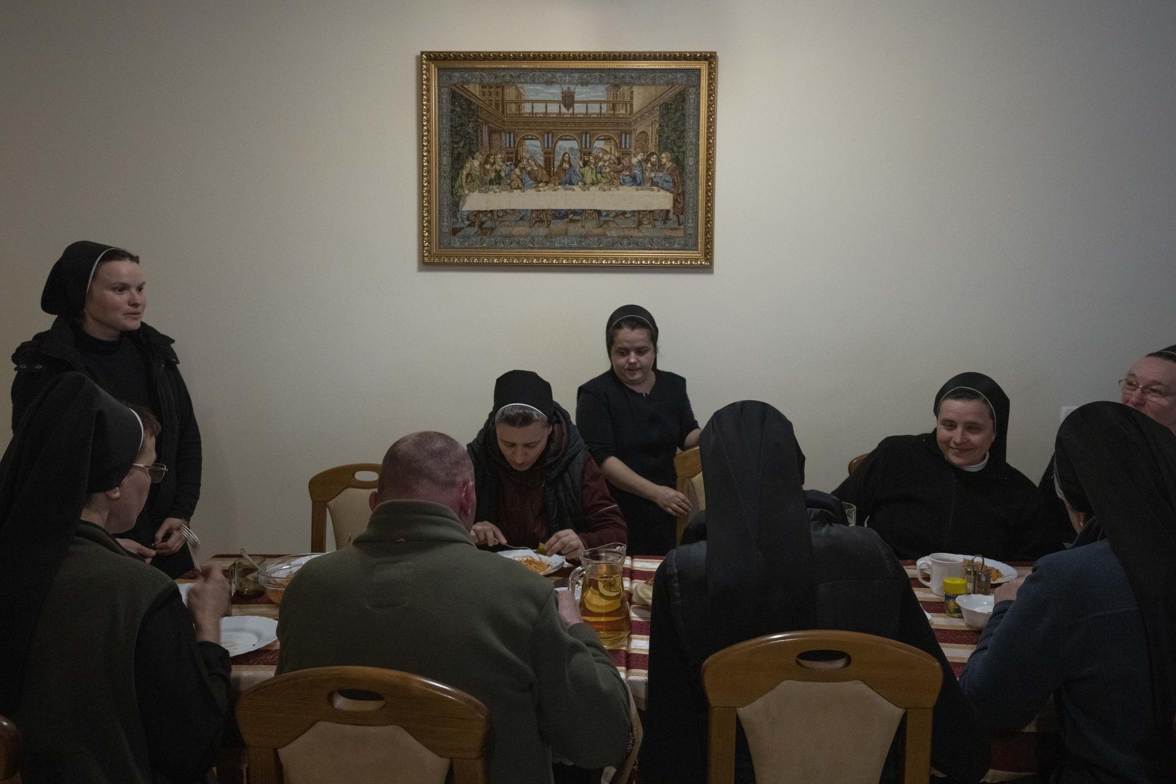 Ukraine's nuns open monastery doors to the displaced - Nuns prepare dinner.