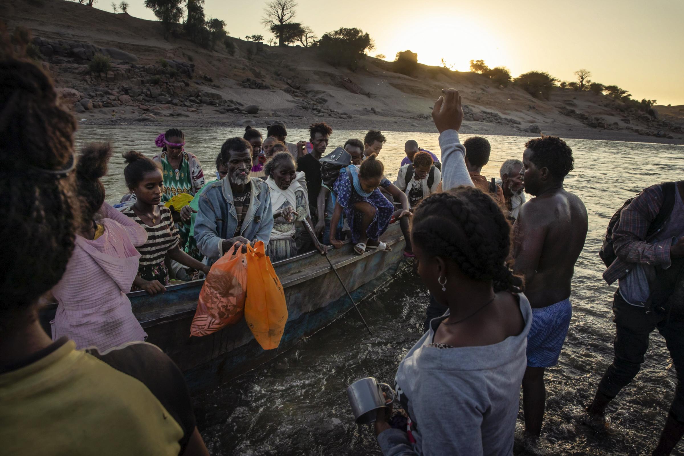 Tigrayan refugees arrive on the banks of the Tekeze River.