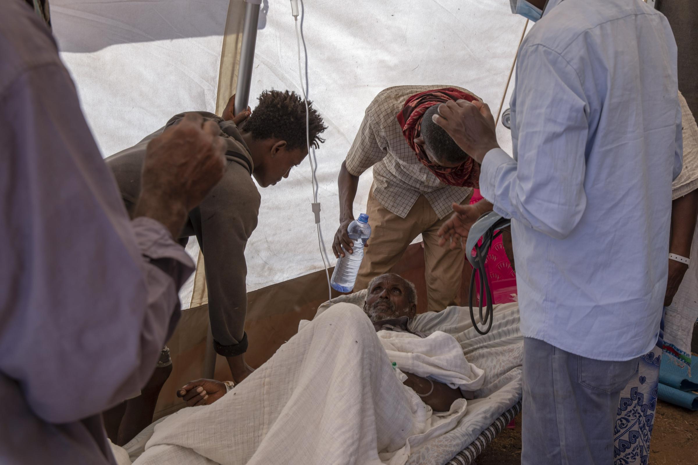War forces thousands of Tigrayan's into Sudan - Nurses tend to an elderly man inside a clinic run by...