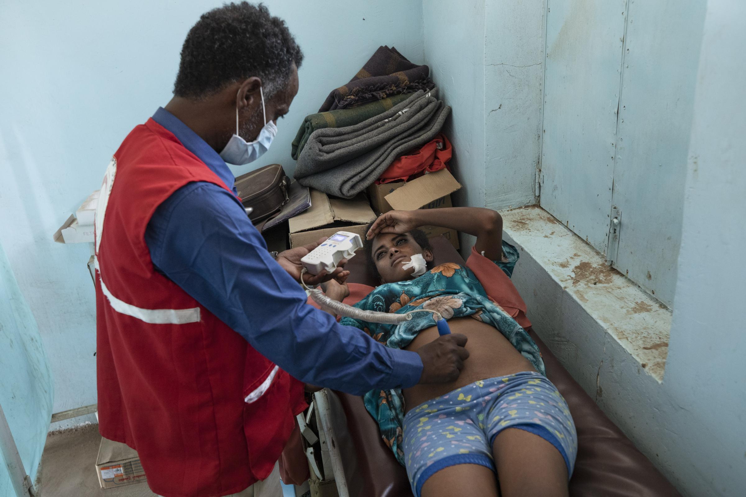 Dr. Tewodros Tefera, performs an ultrasound scan on 5-month-pregnant Tigrayan refugee Rahwa Haile.
