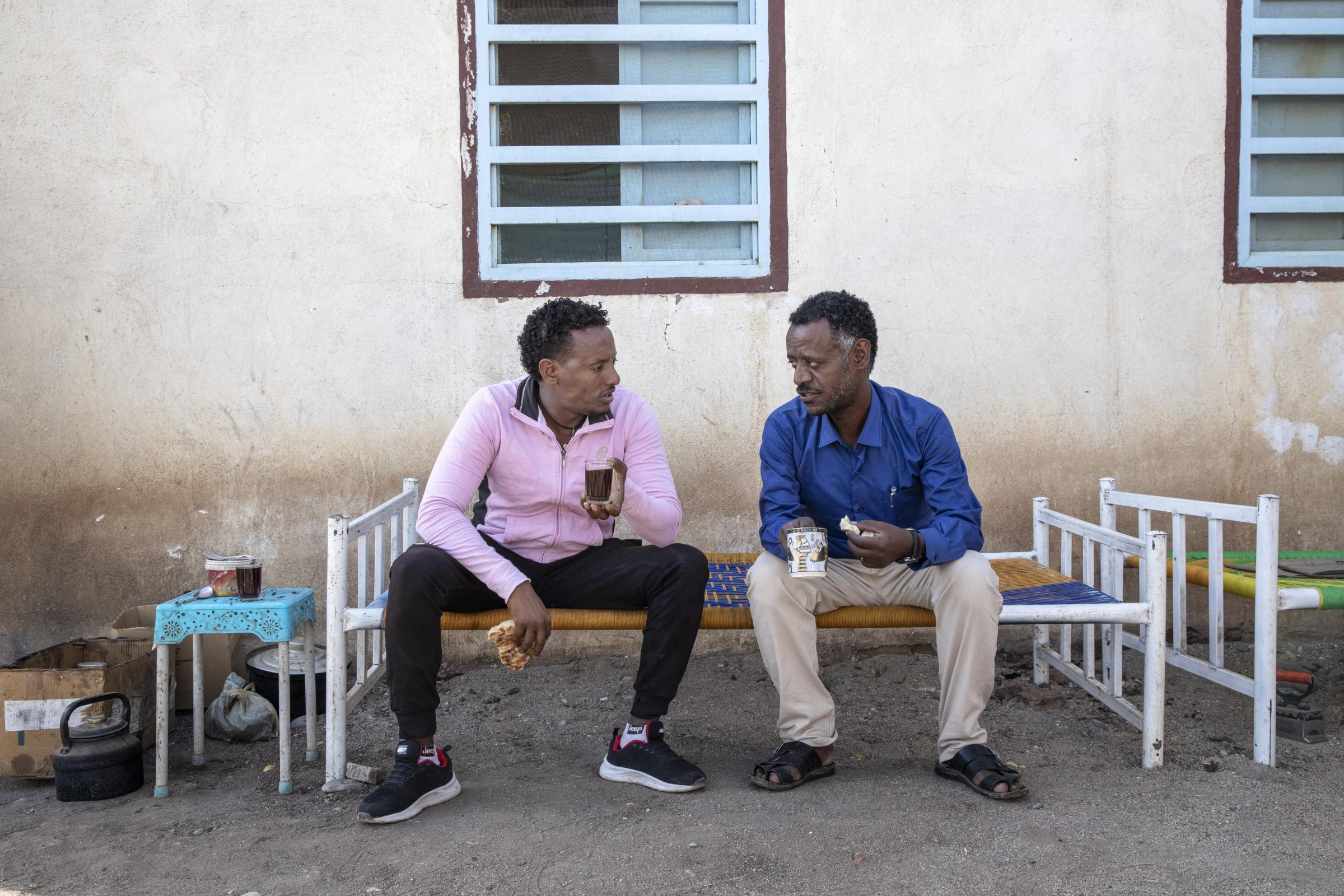 Refugee doctor chronicles Tigray's pain - Dr. Tewodros Tefera drinks tea and eats breakfast with a...
