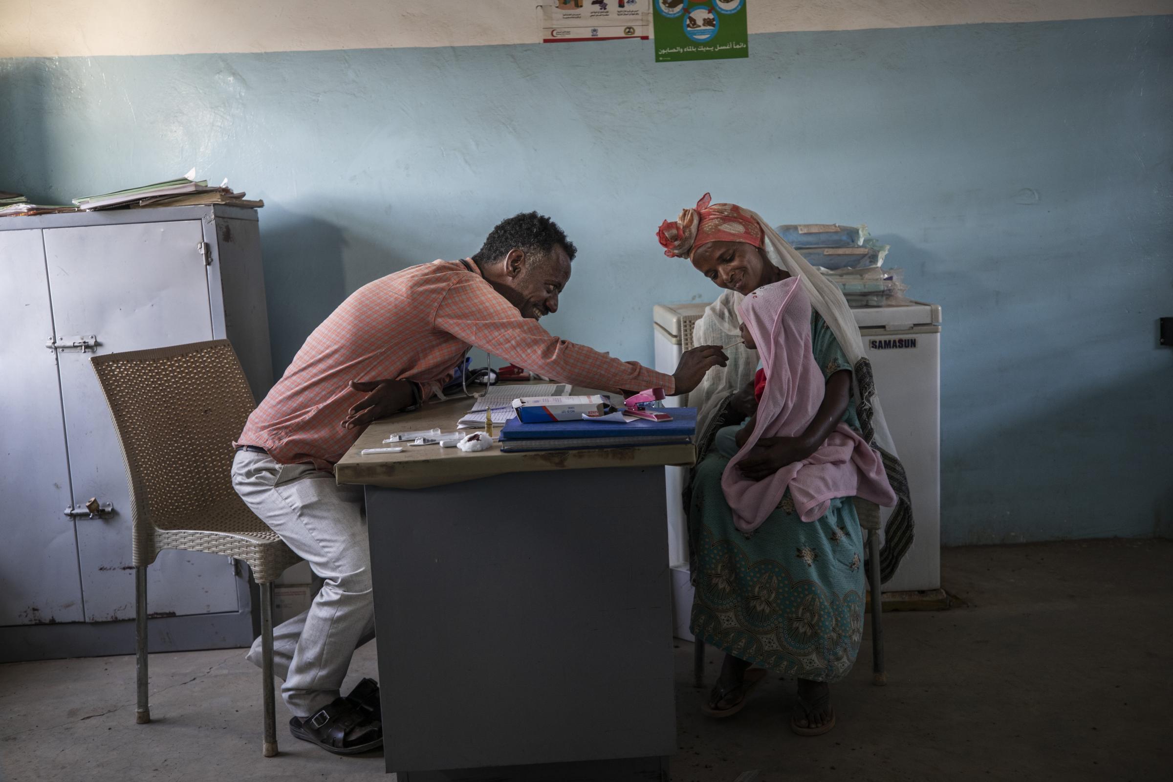 Refugee doctor chronicles Tigray's pain - Dr. Tewodros Tefera treats a patient.