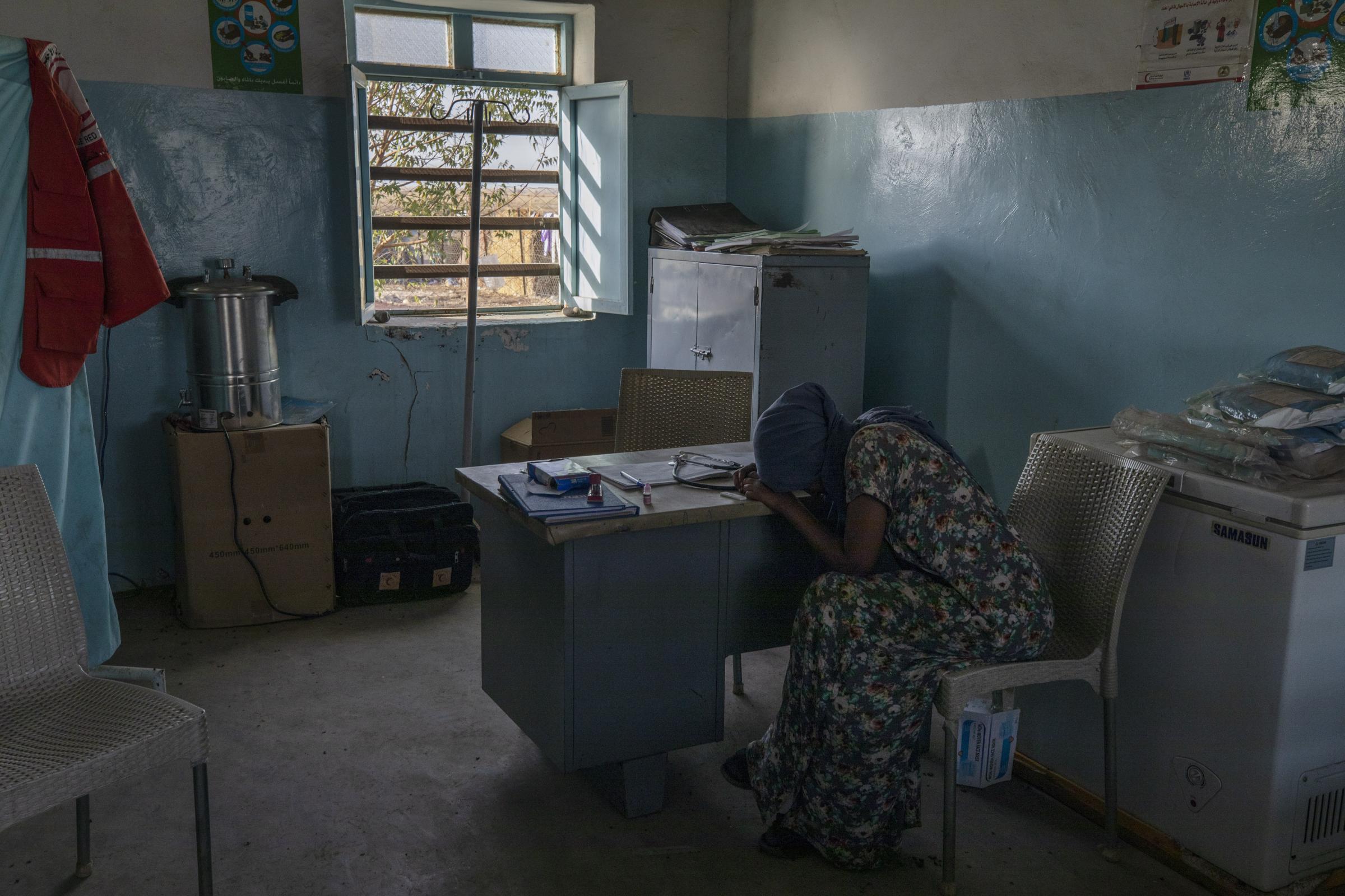  Tigrayan refugee Hareg, 23, from Mekelle, Ethiopia, reacts after learning of her positive malaria test, administered by surgeon and doctor-turned-refugee, Dr. Tewodros Tefera. 